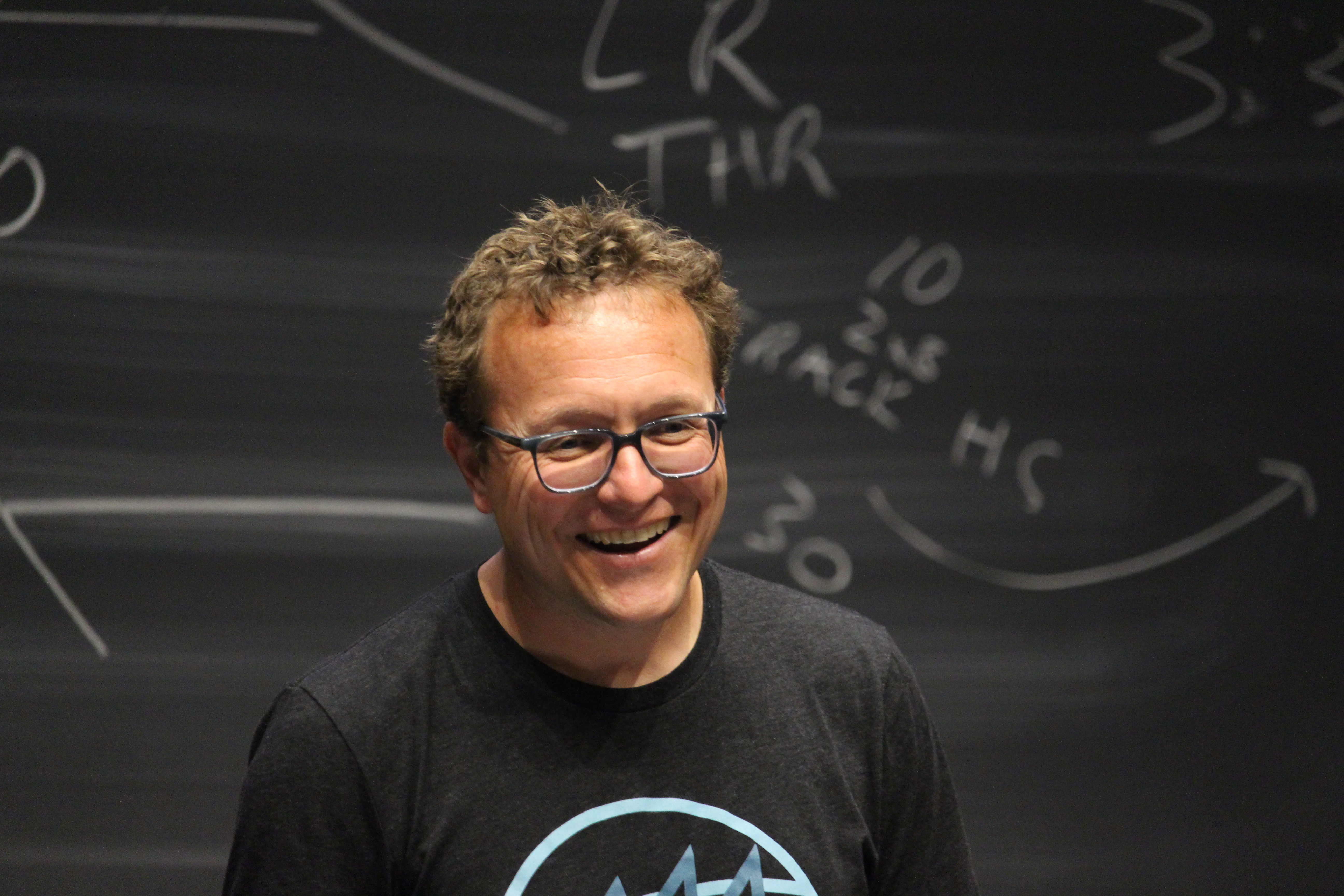 Jay smiling while teaching at running camp