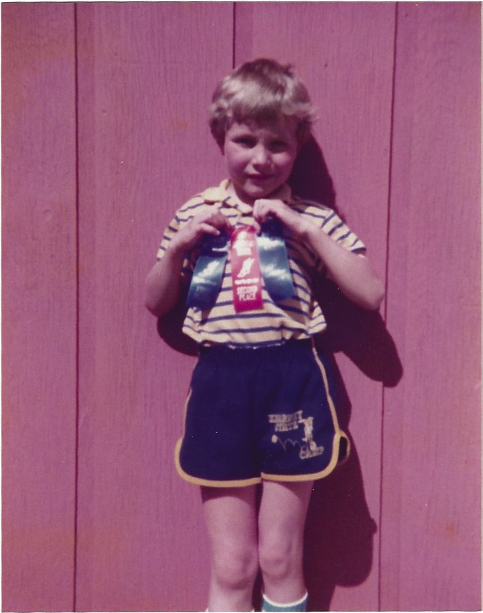 Jay holding his Field Day ribbons